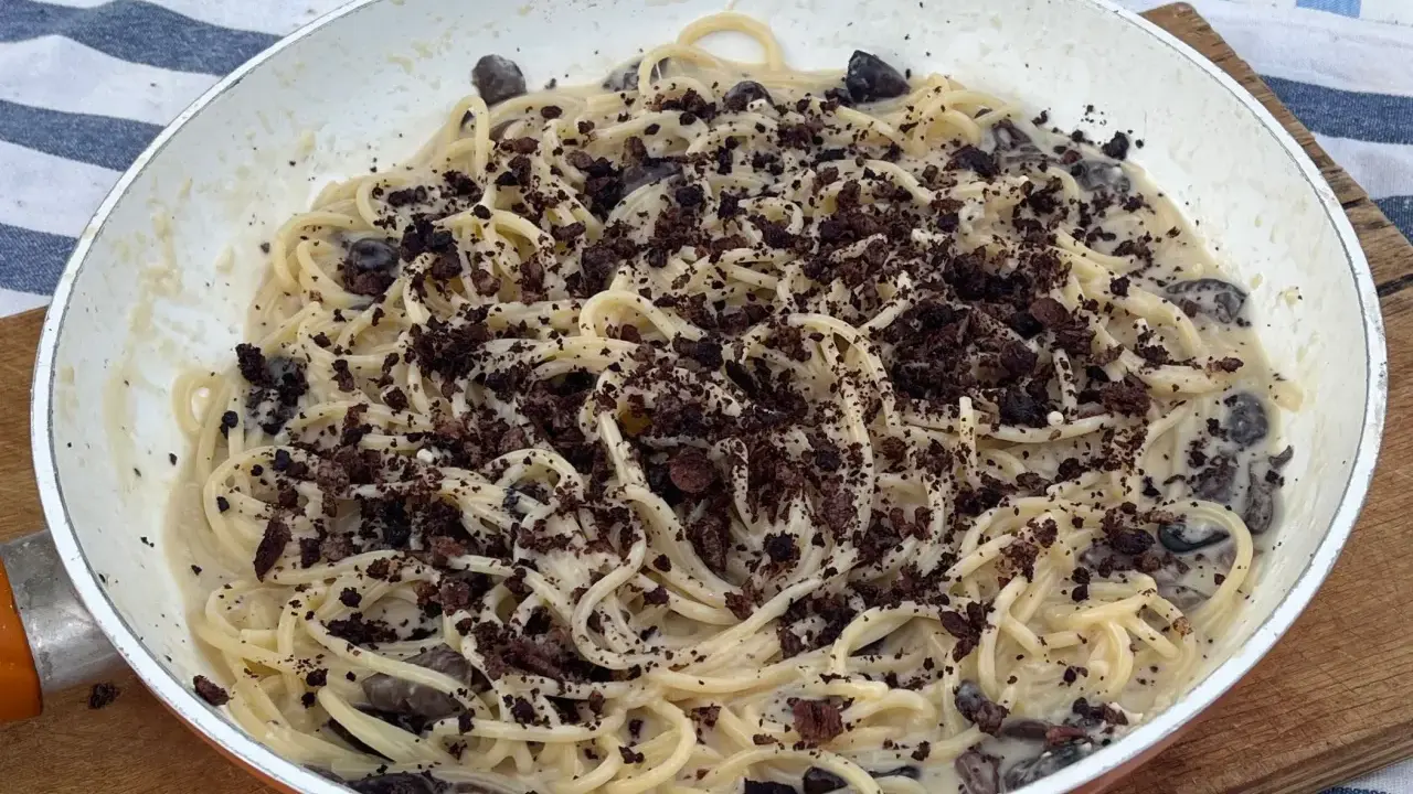 Spaghetti cremosi con olive nere e una spolverata di cacao amaro, un'originale pasta alla cenere.