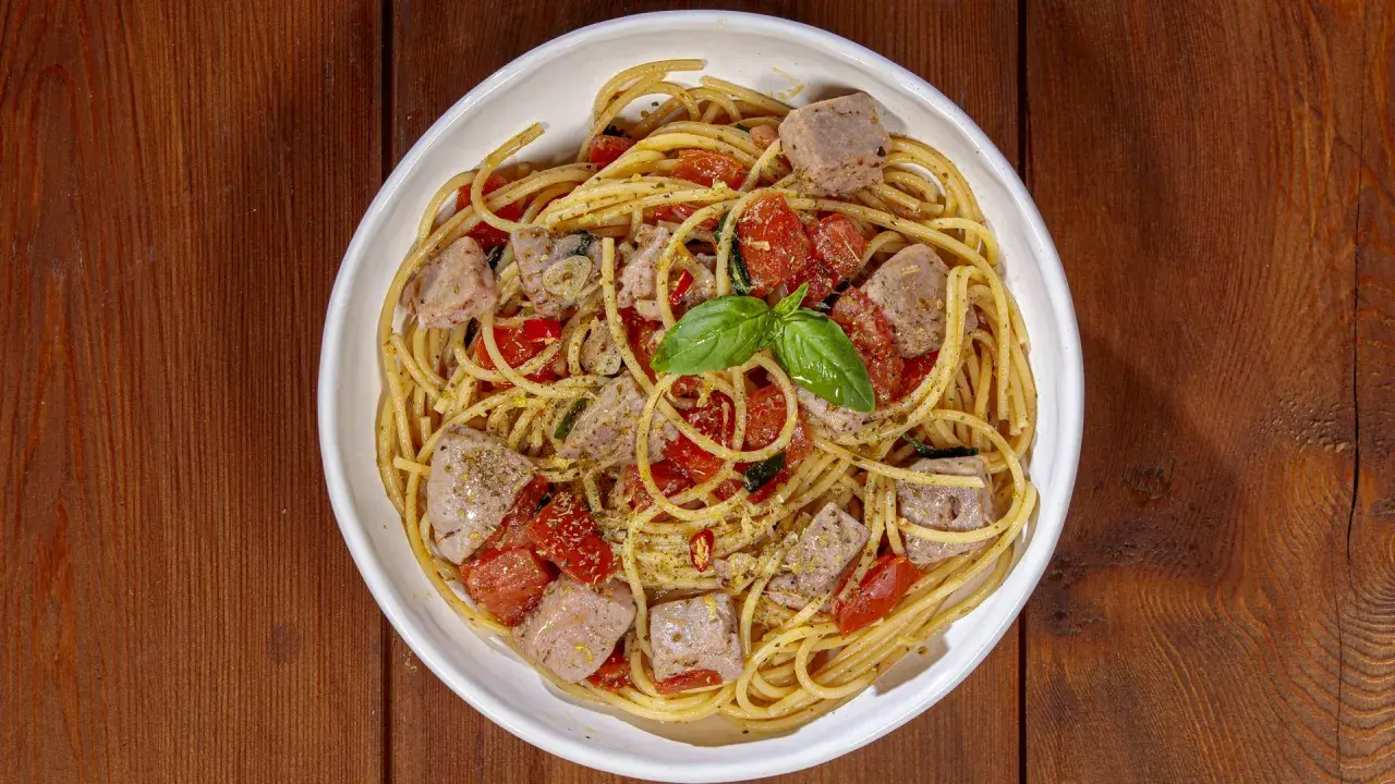 Spaghetti al tonno, un classico profumato, come la spaghetti al tonno ricetta della nonna, con pomodorini e basilico fresco.