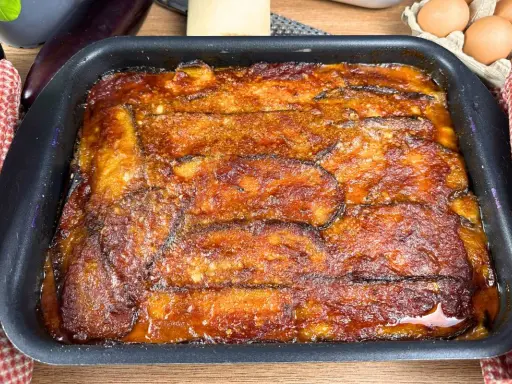 Parmigiana di melanzane appena sfornata, dorata e succulenta, pronta per essere gustata.