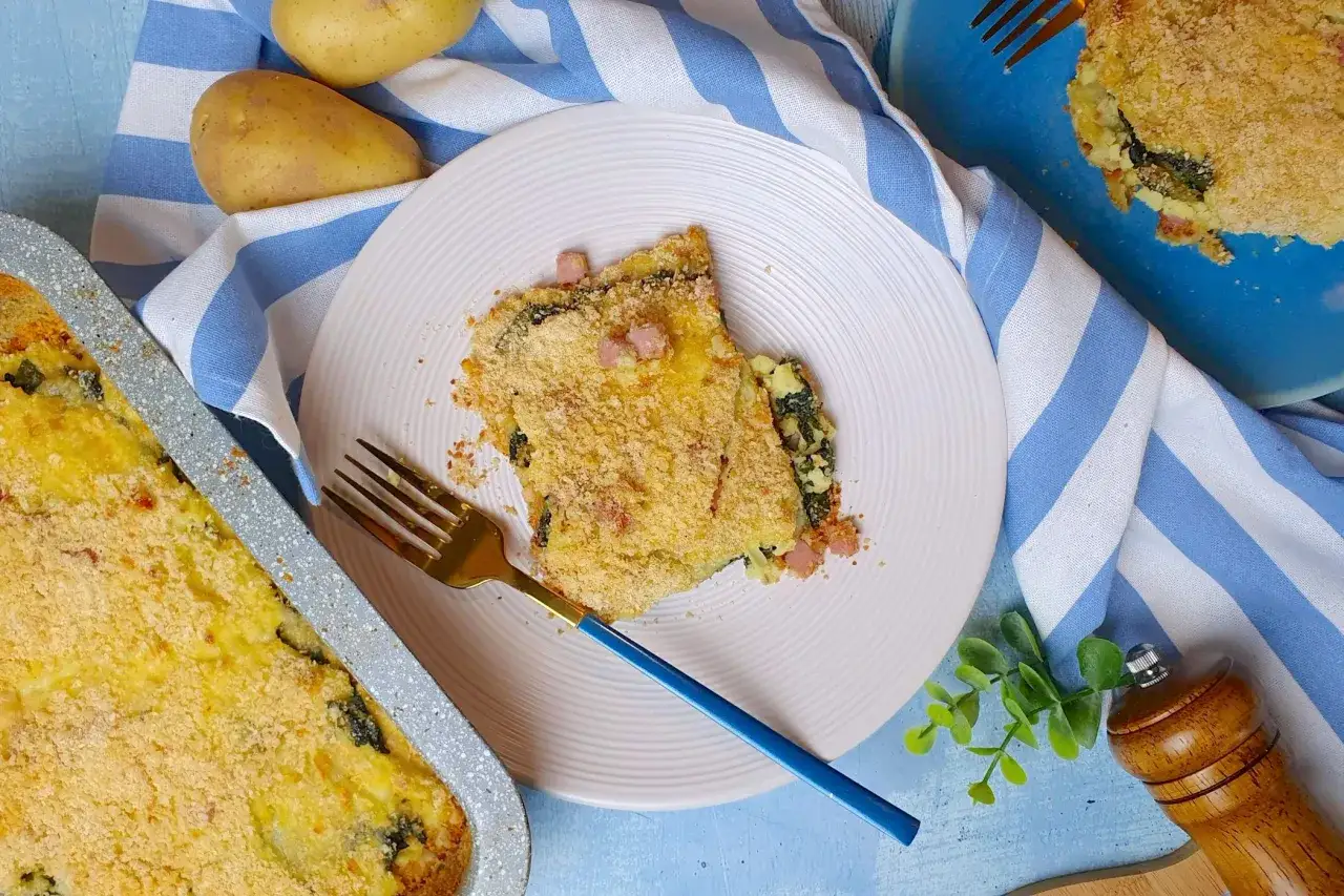 Saporito sformato di patate con spinaci e pancetta, gratinato al forno. Un piatto confortante pronto per essere gustato.